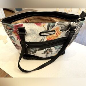 Stone Mountain USA floral print shoulder bag. Leather cutouts on front bottom.